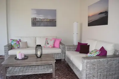a living room with two couches and a coffee table at Modern Apartment with Garden in Kissamos