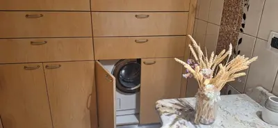 a kitchen with a washing machine and a vase with flowers at Modern Villa in Chania in Perivólia