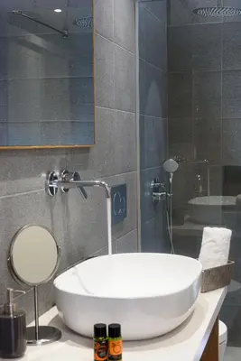 a bathroom with a white sink and a mirror at Casa Teresa | Near Sandy Beach in Chania Town