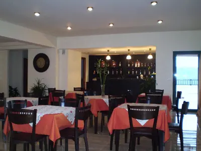 a restaurant with tables and chairs with red table cloth at Roubini Apartments in Falasarna
