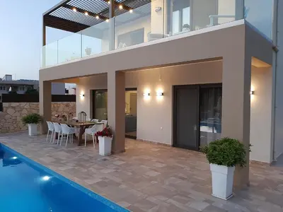 a patio with a table and chairs in a house at Platanias Villa Mirsini in Plataniás
