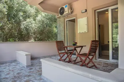 a patio with two chairs and a table at Antartisa B&B in Límni