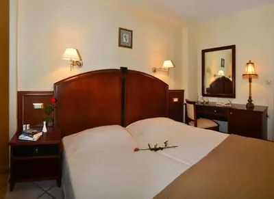 a hotel room with a bed with a flower on it at Antilia Apartments in Tavronitis