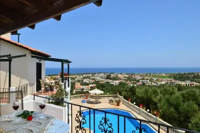 a villa with a balcony with a swimming pool at Antilia Apartments in Tavronitis