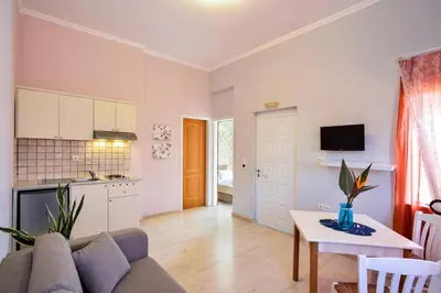 a living room with a couch and a table at Poseidon Apartments in Kato Daratso