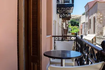 a table and chairs sitting on a balcony at Narkissos 'SUPERB' in Chania Town