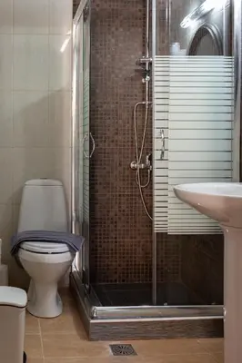 a bathroom with a shower and a toilet and a sink at Narkissos 'SUPERB' in Chania Town