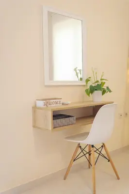 a desk with a white chair and a mirror at NeSo - Peter's Flat steps to Beach with Great Views in Kolymvari