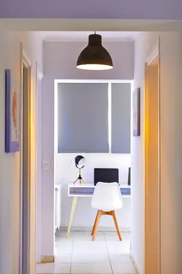a room with a desk with a laptop and a chair at Sunny Luxury Apartment in Chania Town