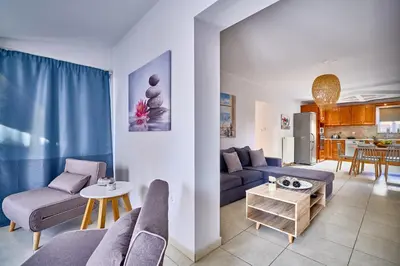 a living room with a couch and a table at Sunny Luxury Apartment in Chania Town