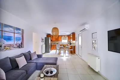 a living room with a couch and a table at Sunny Luxury Apartment in Chania Town