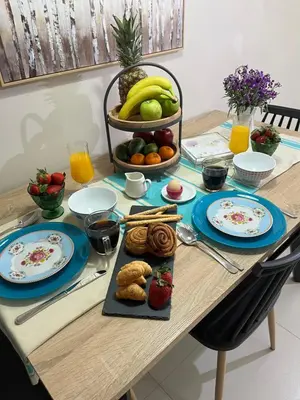 a table topped with plates of food and fruit at Konstantina Apartment near the Beach in Chania Town