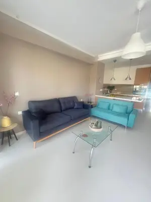 a living room with a blue couch and a table at Konstantina Apartment near the Beach in Chania Town