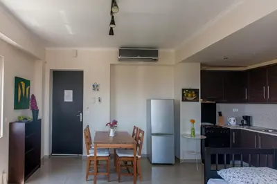 a kitchen with a table and chairs and a refrigerator at Paleochora Houses N2 in Palaiochóra