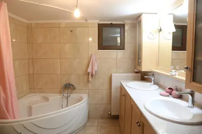 a bathroom with a tub and two sinks and a tub at Chrisas Apartment Chania in Chania Town