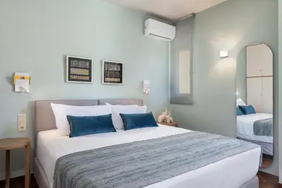 a bedroom with a large bed with blue pillows at Vilia House on the Hill - Luxury Villa with Heated Pool near Chania in Chania Town