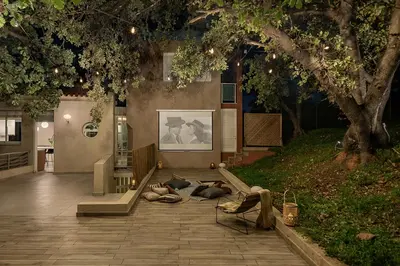 a group of people laying on the ground in a courtyard at Vilia House on the Hill - Luxury Villa with Heated Pool near Chania in Chania Town