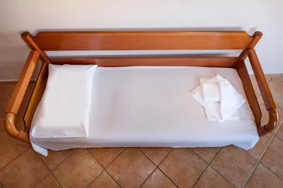 a bed with a wooden head board with two pillows at Irinoula Dreams in Kolymvari