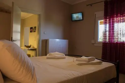 a bedroom with a bed with two towels on it at Lydia's Apartment in Stílos