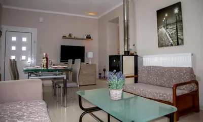 a living room with a couch and a table at Lydia's Apartment in Stílos