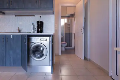 a kitchen with a washing machine in a kitchen at Like Home in Agia Marina Nea Kydonias