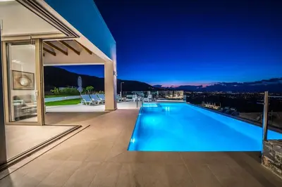 a swimming pool in the middle of a house at Villa Con Vista- Heated Pool 4 bdr sleeps 8 in Tsikalariá