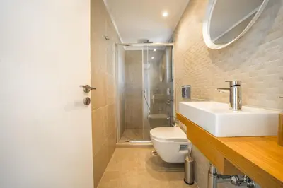a bathroom with a sink and a toilet and a shower at Villa Con Vista- Heated Pool 4 bdr sleeps 8 in Tsikalariá