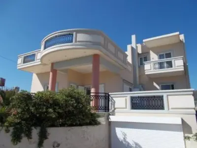 a large apartment building with a balcony and gate at Panoramic Balos Sea View House in Kissamos