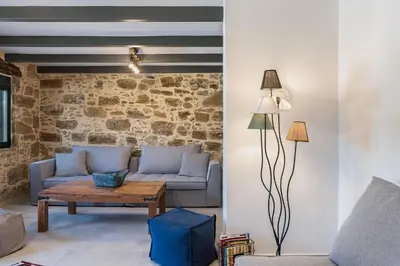 a living room with a couch and a table at Trialonia Luxury Villa in Kissamos