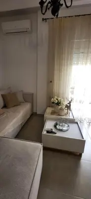 a living room with a couch and a table at A Pleasant Stay in Chania in Chania Town