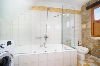 a bathroom with a tub and a toilet and a shower at 4-bedroom Topolia House in Topólia