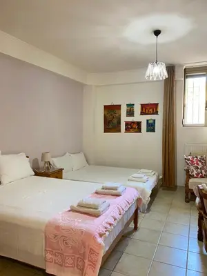 a bedroom with two beds and a window at Villa Pandora - Petit Bonheur in Maleme