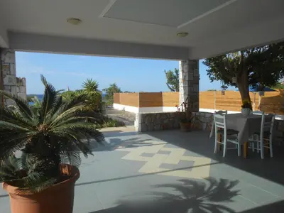 a patio with a table and chairs on it at Serenity Hideaway in Palaiochóra