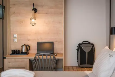 a bedroom with a desk with a computer and a deskicterictericterictericter at Aequor Luxury Rooms & Apartments in Kato Daratso