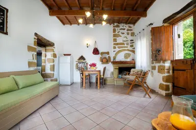 a living room with a couch and a table at Topolia 1 Bedroom Villa in Topólia