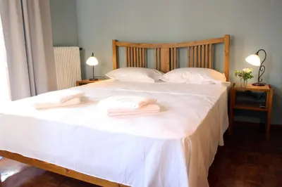 a bedroom with a bed with two towels on it at Spacious townhouse close to Chania center in Chania Town