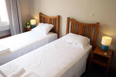 two beds sitting next to each other in a bedroom at Spacious townhouse close to Chania center in Chania Town