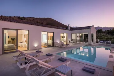 a villa with a swimming pool and patio furniture at Villa White Harmony in Khámbatha