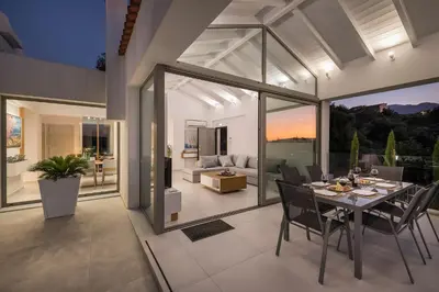 a dining room with a table and chairs at Villa White Harmony in Khámbatha