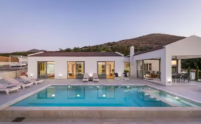 a villa with a swimming pool and a house at Villa White Harmony in Khámbatha