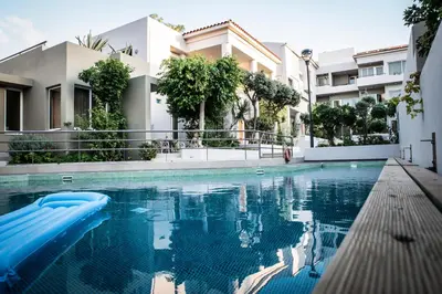 a swimming pool in front of a building at Creta Elena in Chania Town