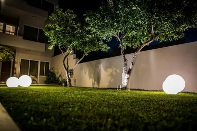 a lawn with three lights in front of a building at Creta Elena in Chania Town