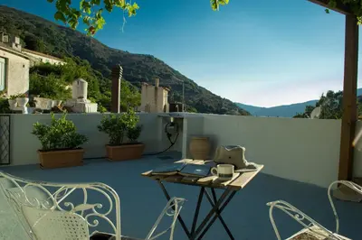 a patio with a table and chairs on a balcony at Feneri- cozy Apartment 20' from Elafonisi beach in Elafonisi