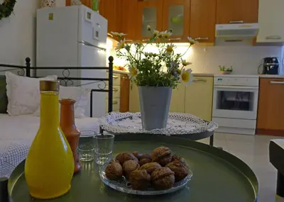 a table with a plate of food and a bottle of juice at Diamant's Place with Treehouse Garden in Kounoupidhianá
