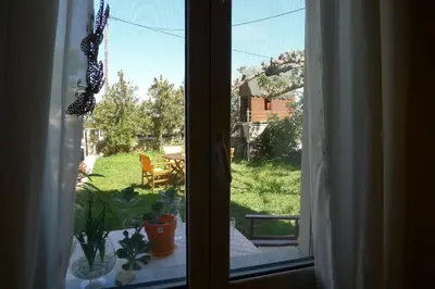 a window with a view of a yard at Diamant's Place with Treehouse Garden in Kounoupidhianá