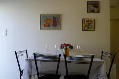 a table with wine glasses and a vase on it at Diamant's Place with Treehouse Garden in Kounoupidhianá