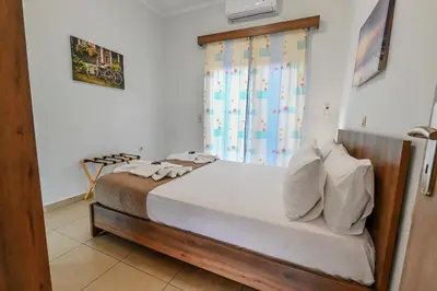 a bedroom with a bed and a window at Stelios & Stavros Apartment in Kissamos