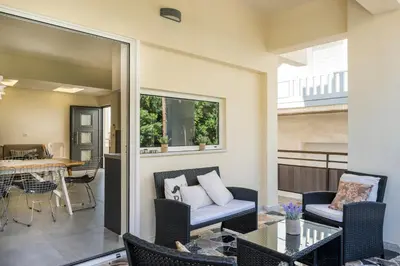 a patio with a couch and chairs and a table at Casa Di Xenia in Chania Town