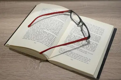 a book with a pair of glasses on top of it at Casa Di Xenia in Chania Town