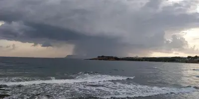 a storm over the ocean with a rainbow in the sky at Lily of Crete 1 - Sea & Beach front Apartment in Kalamaki Chanion